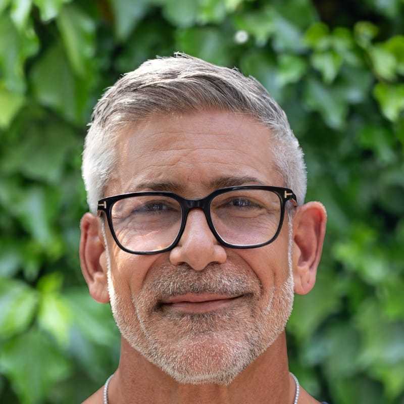 Portrait of Yogi, a professional stylist at hair, showcasing their expertise and style.