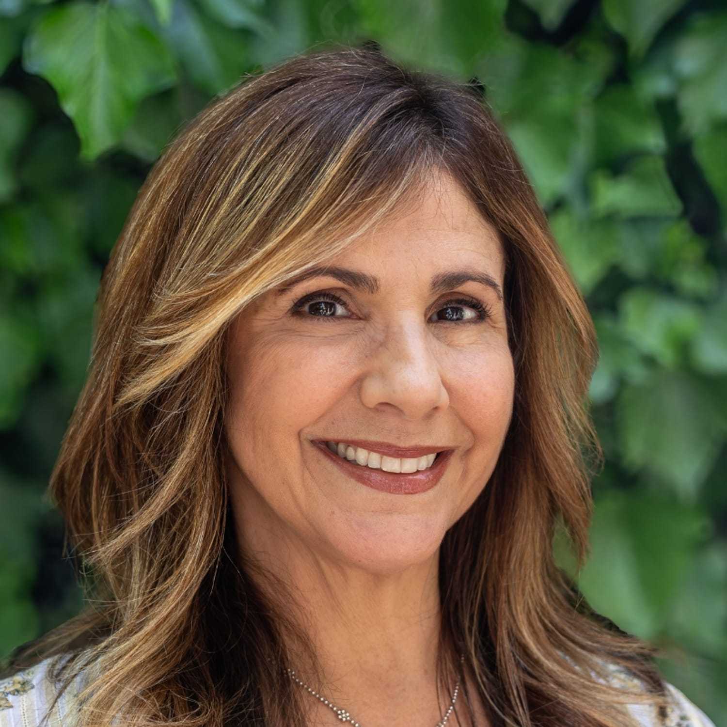 Portrait of Gina, a professional stylist at hair, showcasing their expertise and style.