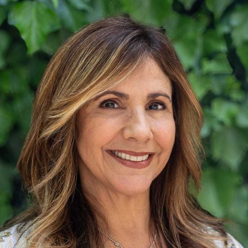 Portrait of Gina, a professional stylist at hair, showcasing their expertise and style.