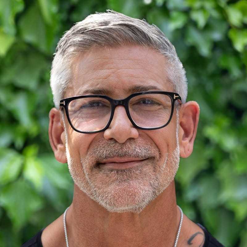 Portrait of Yogi, a professional stylist at hair, showcasing their expertise and style.