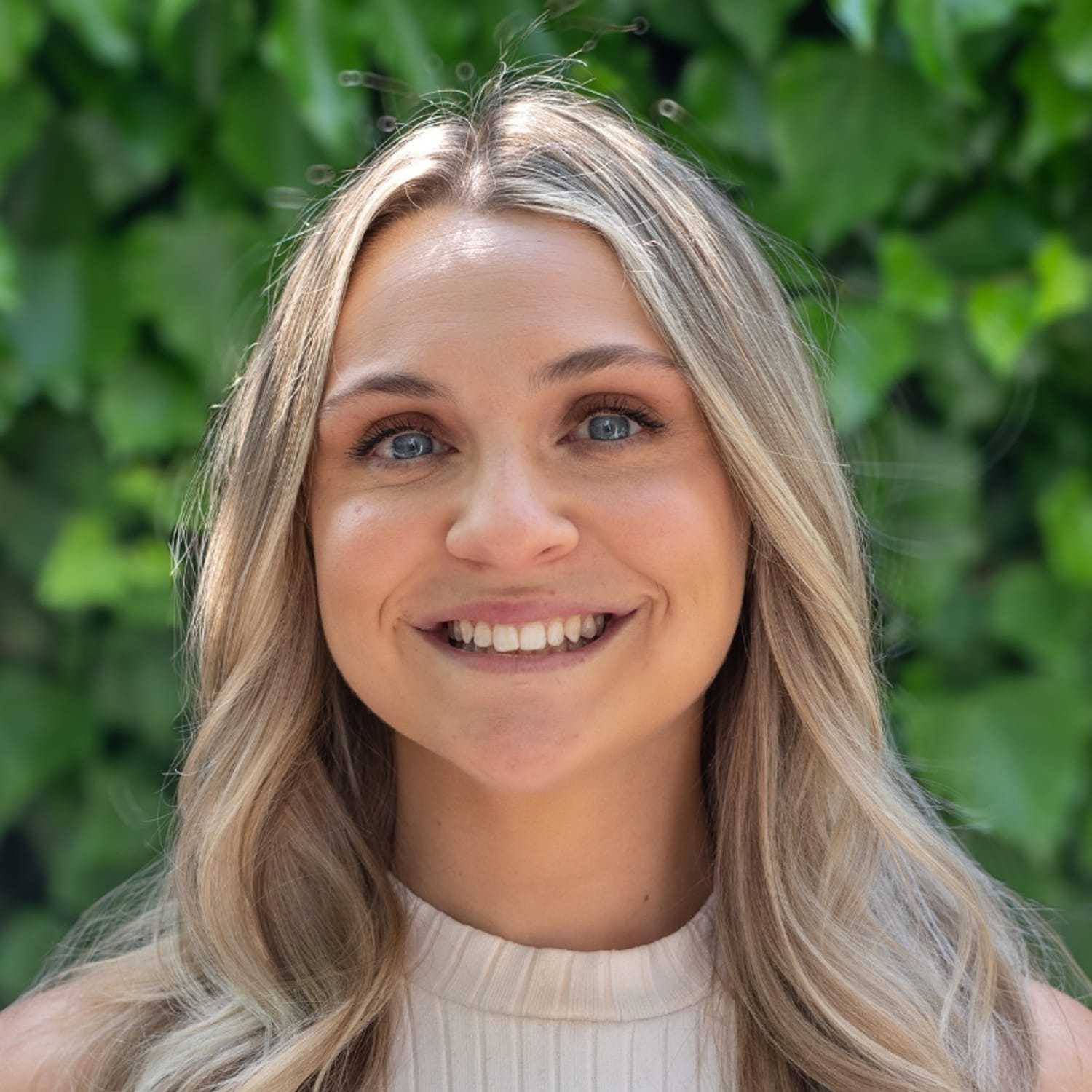 Portrait of Ashley, a professional stylist at hair, showcasing their expertise and style.