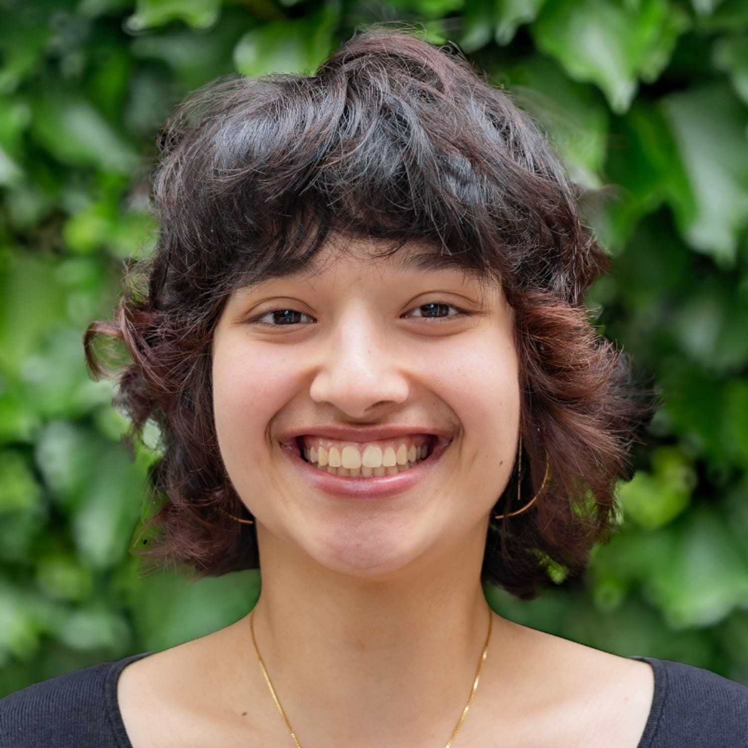 Portrait of Amelia, a professional stylist at hair, showcasing their expertise and style.